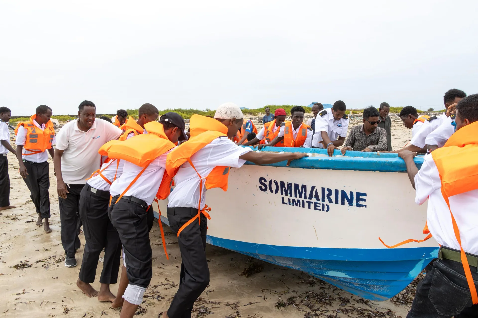 Sommarine team and visiting delegation supporting a boat launch